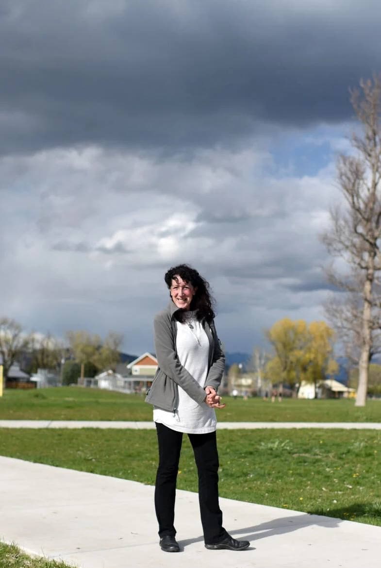 Tajali standing outside her school under a wide Montana sky